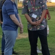 Wendy Morethorpe listens while a Western Farm Workers Association volunteer translates at a migrant housing meeting and distribution.